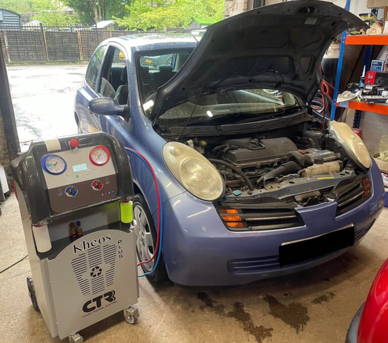 A car in the workshop with the bonnet open