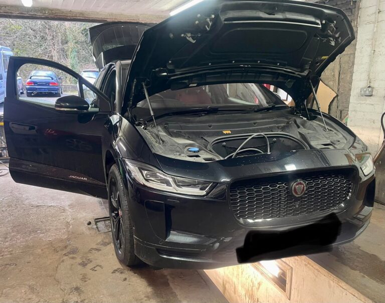 A car in the workshop with the bonnet up at Woodside Garage