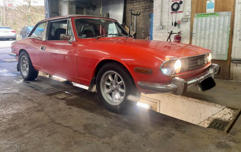 A classic car on the ramp at Woodside Garage